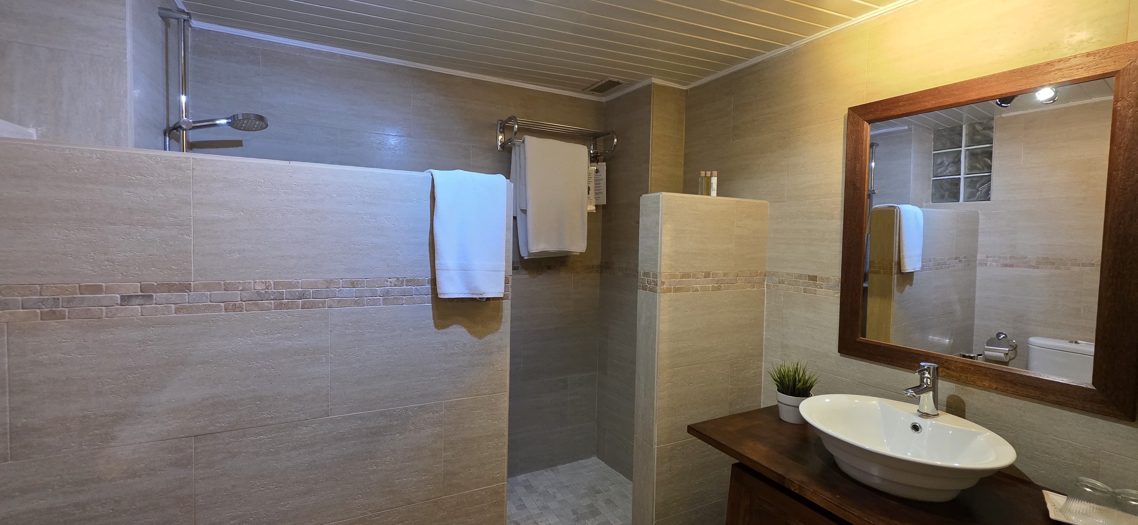 A bathroom at La Villa Marbella with a stone basin and soft morning light